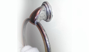 Corrosion on copper towel ring in bathroom